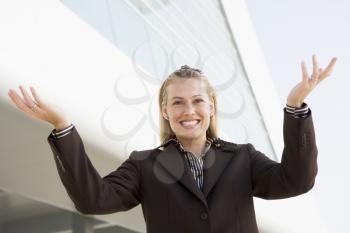 Royalty Free Photo of a Woman Standing With Her Arms Raised
