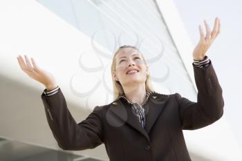 Royalty Free Photo of a Woman Outside With Her Arms Raised