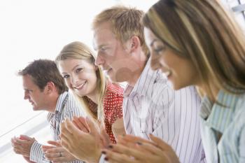 Royalty Free Photo of Four Young Businesspeople Applauding