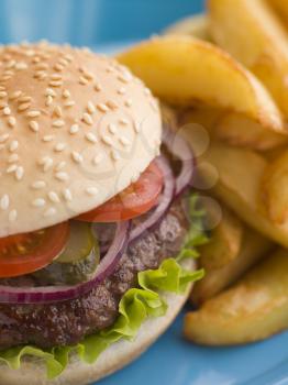 Royalty Free Photo of a Beefburger With Salad and Pickles in a Sesame Seed Bun With Chips