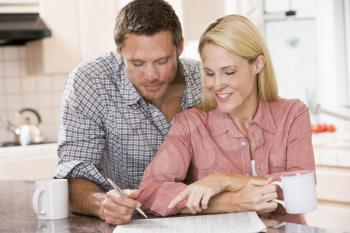 Royalty Free Photo of a Couple Reading a Newspaper