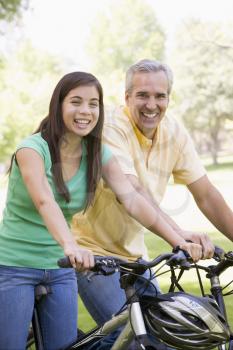 Royalty Free Photo of a Man and a Girl on Bikes