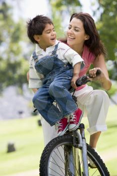 Royalty Free Photo of a Woman and Child on a Bike