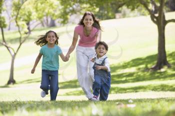 Royalty Free Photo of a Woman Running With Her Children