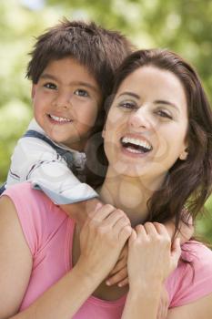 Royalty Free Photo of a Mother and Child Hugging Outside