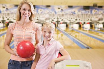 Royalty Free Photo of a Woman and Girl at a Bowling Alley