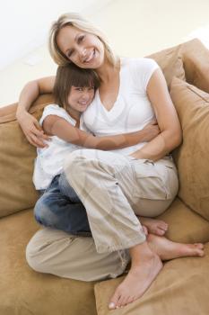 Royalty Free Photo of a Mother and Daughter Cuddling on a Couch