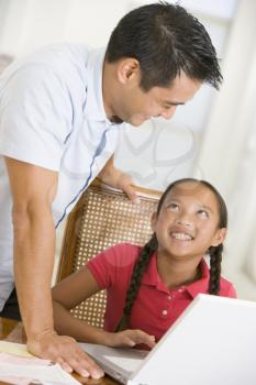 Royalty Free Photo of a Father With a Daughter at a Laptop