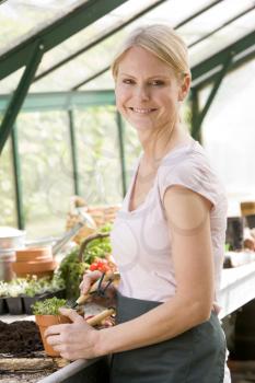 Royalty Free Photo of a Woman in a Greenhouse