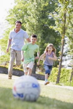 Royalty Free Photo of a Man and Two Children Outside