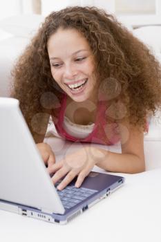 Royalty Free Photo of a Woman Lying on a Bed With a Laptop