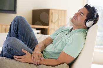 Royalty Free Photo of a Man Sleeping and Listening to Music