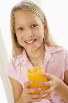 Royalty Free Photo of a Girl With a Glass of Orange Juice