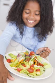 Royalty Free Photo of a Girl Eating a Salad