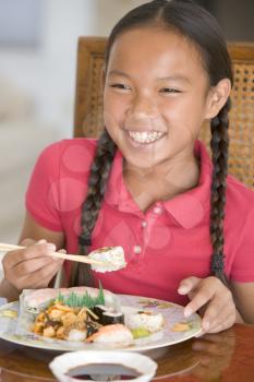 Royalty Free Photo of a Girl Eating Chinese Food