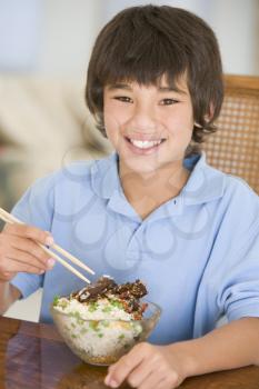 Royalty Free Photo of a Boy Eating Chinese Food