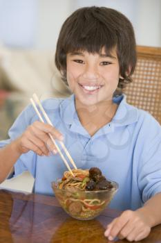 Royalty Free Photo of a Boy Eating Chinese Food