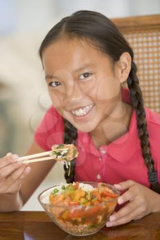 Royalty Free Photo of a Girl Eating Chinese Food