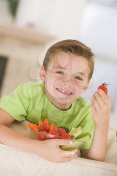 Royalty Free Photo of a Boy Eating a Bowl of Vegetables