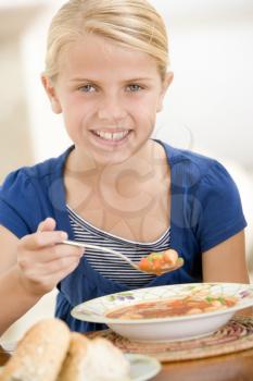 Royalty Free Photo of a Girl Eating Soup