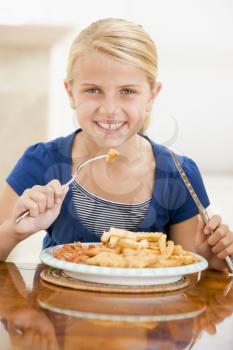 Royalty Free Photo of a Girl Eating Fish and Chips