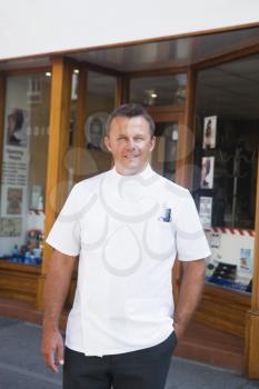 Royalty Free Photo of a Man Outside a Barbershop