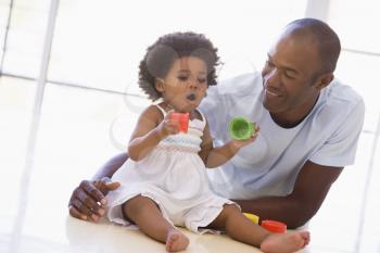 Royalty Free Photo of a Father and Daughter Playing on the Floor