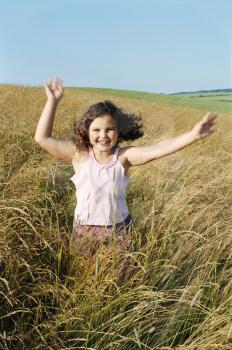 Royalty Free Photo of a Girl Running in a Field