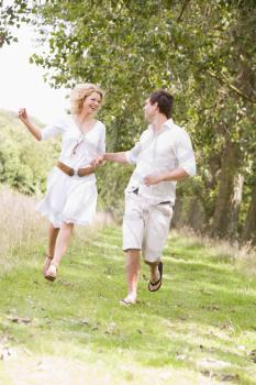 Royalty Free Photo of a Couple Running on a Path