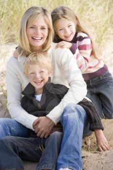 Royalty Free Photo of a Mother and Two Children at the Beach