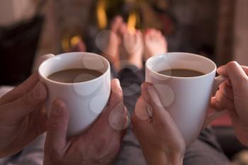 Royalty Free Photo of People Having a Hot Drink by a Fire