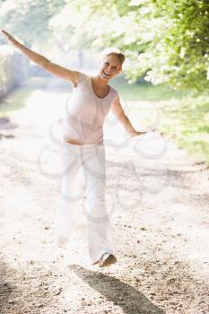 Royalty Free Photo of a Woman Walking on a Trail