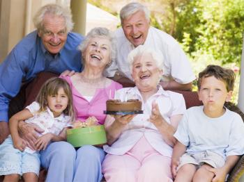 Royalty Free Photo of Grandchildren Celebrating With Grandparents