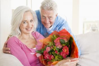 Royalty Free Photo of a Man Giving His Wife Flowers