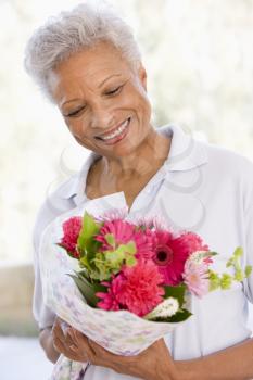 Royalty Free Photo of a Woman Holding Flowers