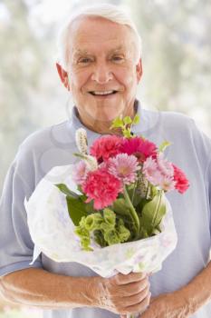 Royalty Free Photo of a Man With Flowers