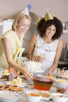 Royalty Free Photo of Women Setting Out a Table of Party Food