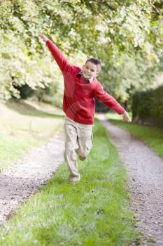 Royalty Free Photo of a Child Running on a Trail