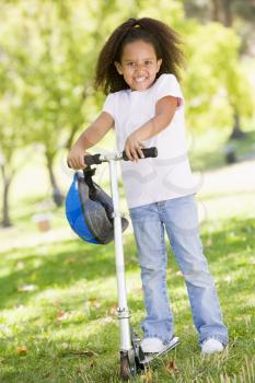 Royalty Free Photo of a Little Girl on a Scooter