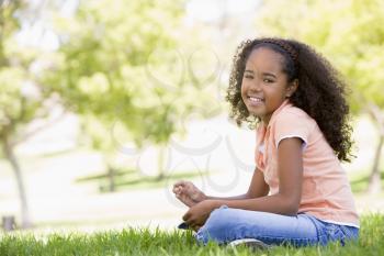 Royalty Free Clipart Image of a Girl Sitting Outside