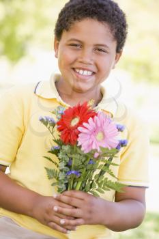 Royalty Free Photo of a Girl Holding Flowers