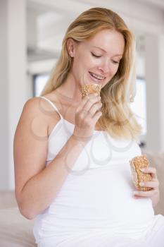 Royalty Free Photo of a Pregnant Woman Eating Bread
