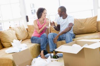 Royalty Free Photo of a Couple Toasting a New Move With Champagne