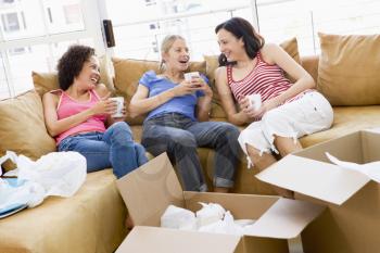 Royalty Free Photo of Three Friends Taking a Break From Unpacking