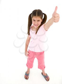 Young girl giving thumbs up smiling