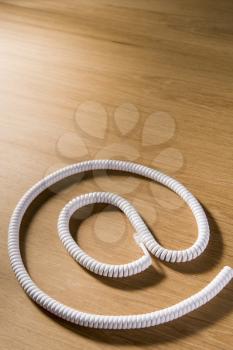 Royalty Free Photo of a Telephone Cord Making an @ Symbol