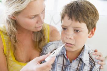 Royalty Free Photo of a Boy Having His Temperature Taken