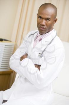 Royalty Free Photo of a Doctor Sitting on a Hospital Bed