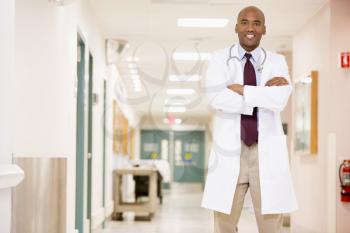 Royalty Free Photo of a Doctor Standing in a Corridor