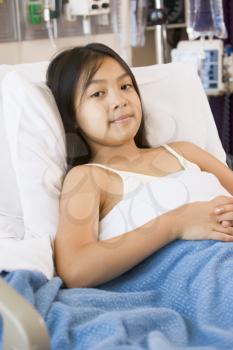 Royalty Free Photo of a Young Girl in a Hospital Bed